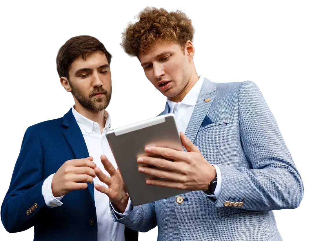 two young businessmen talking at a station holding a tablet